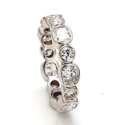 Eternity band with alternating bezel set (14) round and radiant cut diamonds.  D2.72ct.t.w.  Size 6