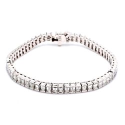 7' Tennis bracelet in 18K WG with half bezel set (60) emerald cut diamonds.  D11.12ct.t.w.