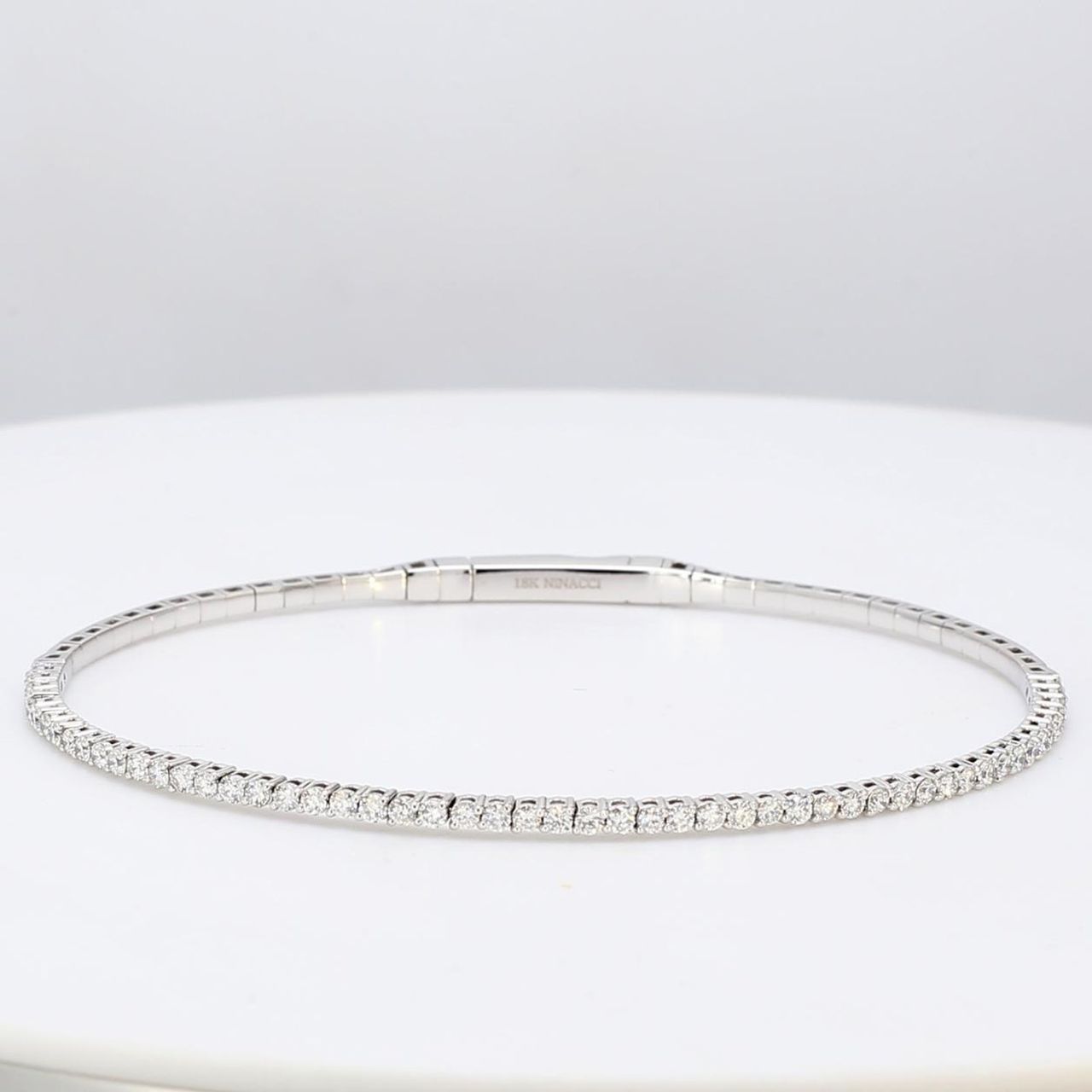 6.25' Lightweight flexible oval shaped bangle in 18K WG with prong set round diamonds.  D1.02ct.t.w.