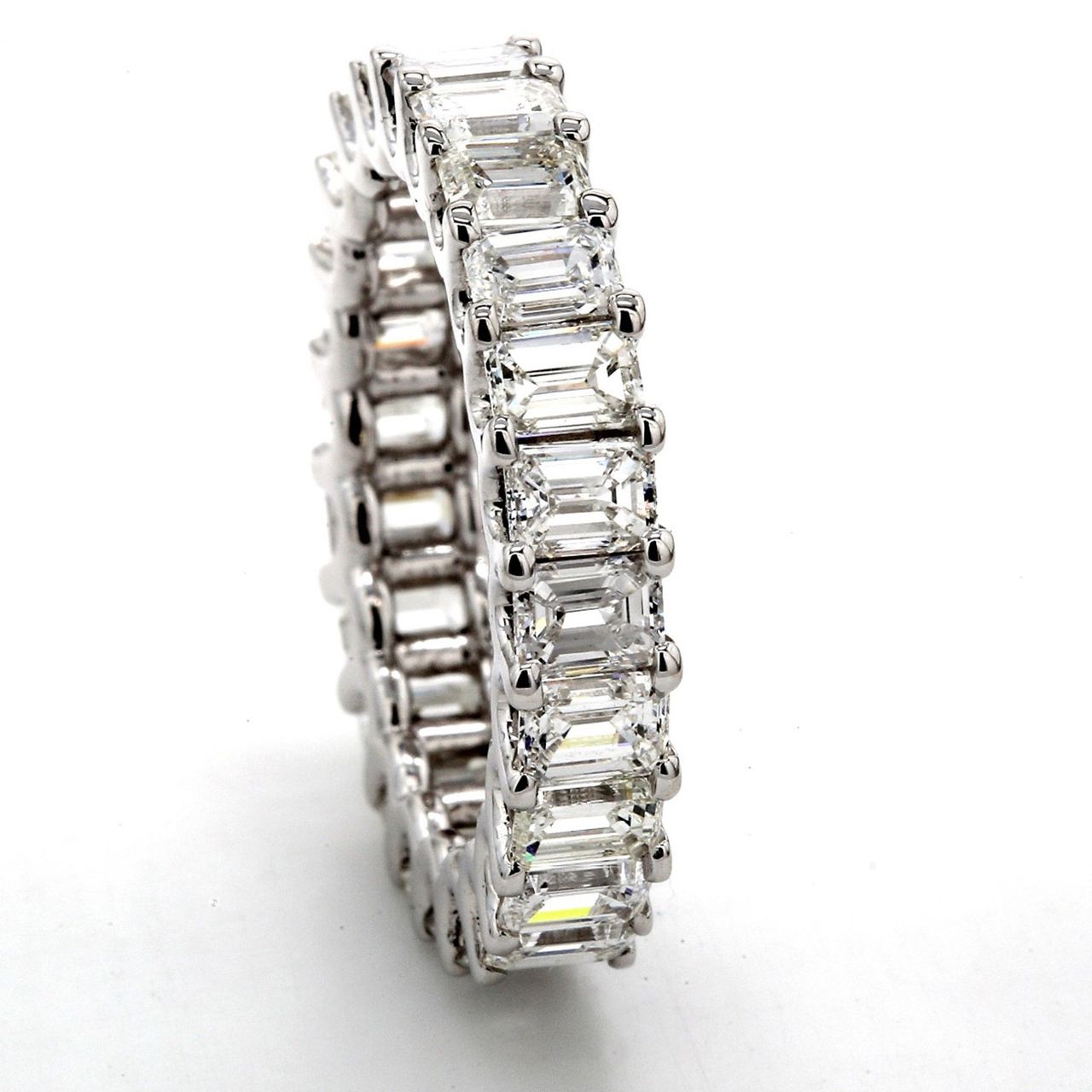Eternity band in 18K WG with shared U-prong set (24) emerald cut diamonds.  D4.65ct.t.w.
