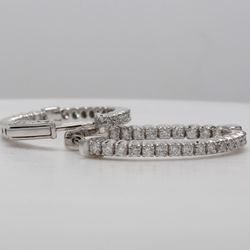 1' Oval shaped inside out hoop earrings with 4-prong set round diamonds.  D1.28ct.t.w.