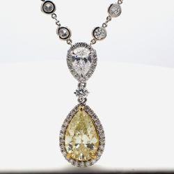 17.5' Halo drop necklace in platinum/18K YG with bezel set rounds, D/SI2 pear, and FLY/SI2 GIA certified pear shape diamond center stone.  D11.12ct.t.w.  (Center - 5.03ct.)