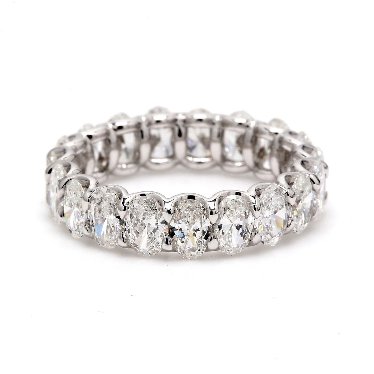 Eternity band in platinum with shared U-prong set (23) oval cut diamonds.  D3.30ct.t.w.  Size 5.25