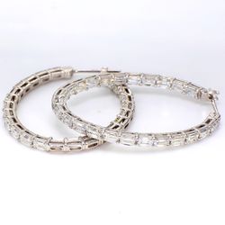 1.5' Oval shaped inside out hoop earrings in 18K WG with shared prong set emerald cut diamonds.  D6.74ct.t.w.