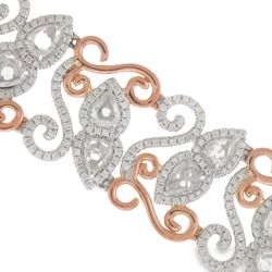 Halo designer bracelet in 18K two-tone with swirl gold lining in rose gold, French pave set rounds around prong set pear shape diamond center stones.  D10.83ct.t.w.