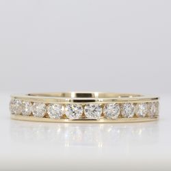 Eternity band in yellow gold with channel set round diamonds.  D1.69ct.t.w.  Size 7