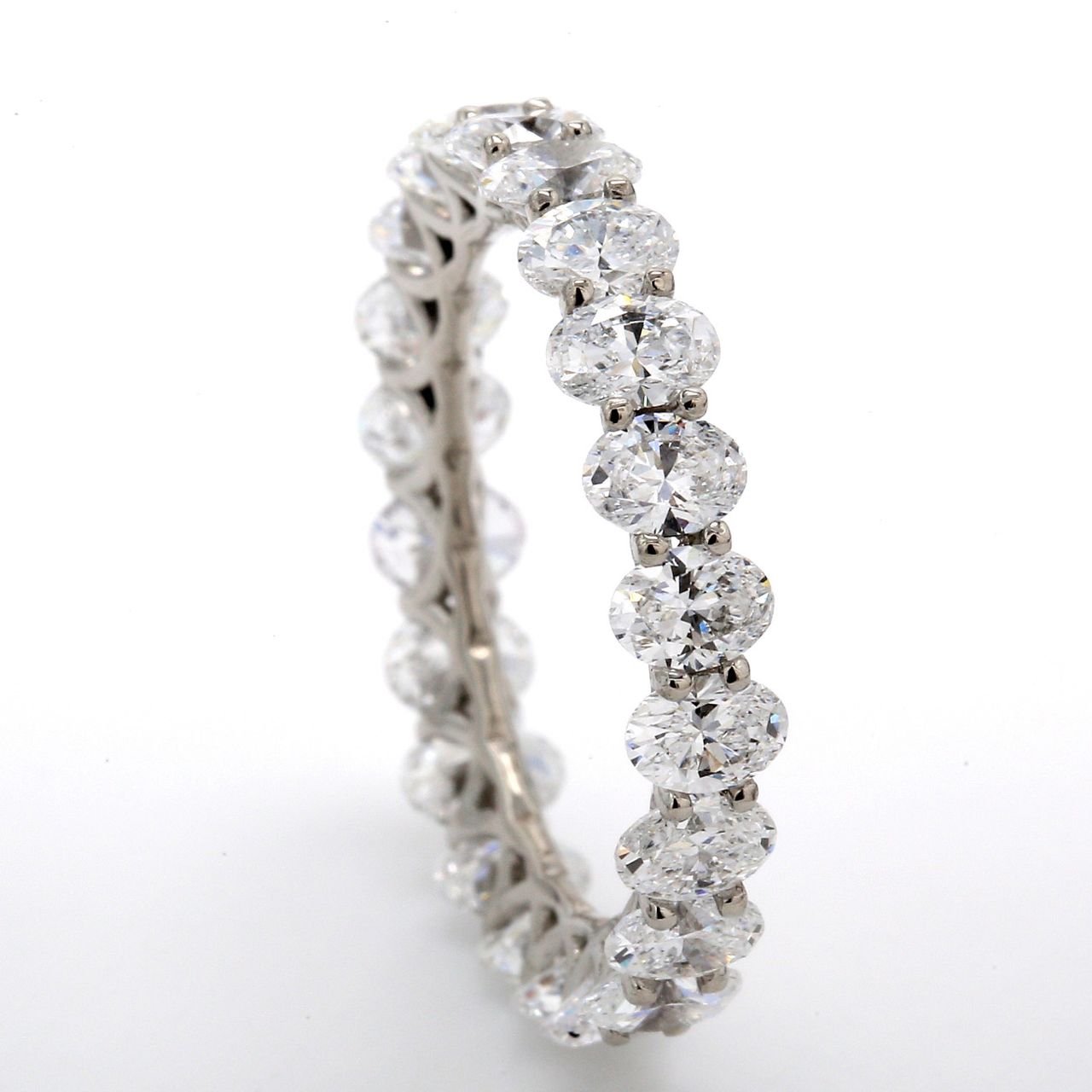 Eternity band in platinum with shared U-prong set (22) oval cut diamonds.  D3.12ct.t.w.  Size 6.25