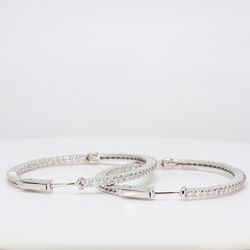 Oval shaped inside out hoop earrings with shared prong set round diamonds.  D2.17ct.t.w.