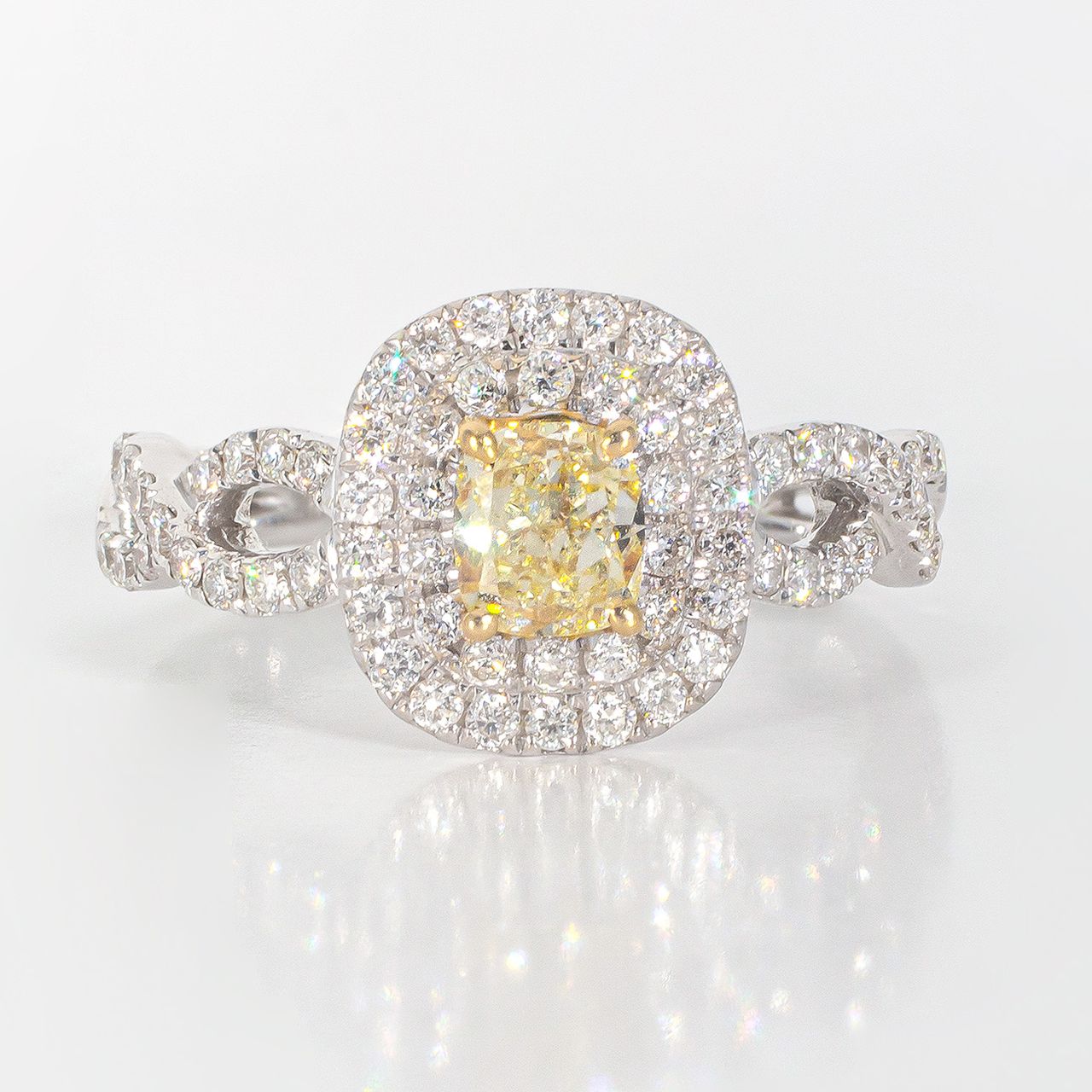 Double halo criss cross shank ring in 18K WG with rounds around a FY cushion cut diamond center stone.  D1.16ct.t.w.  (Center 0.58ct.)  Size 6.75