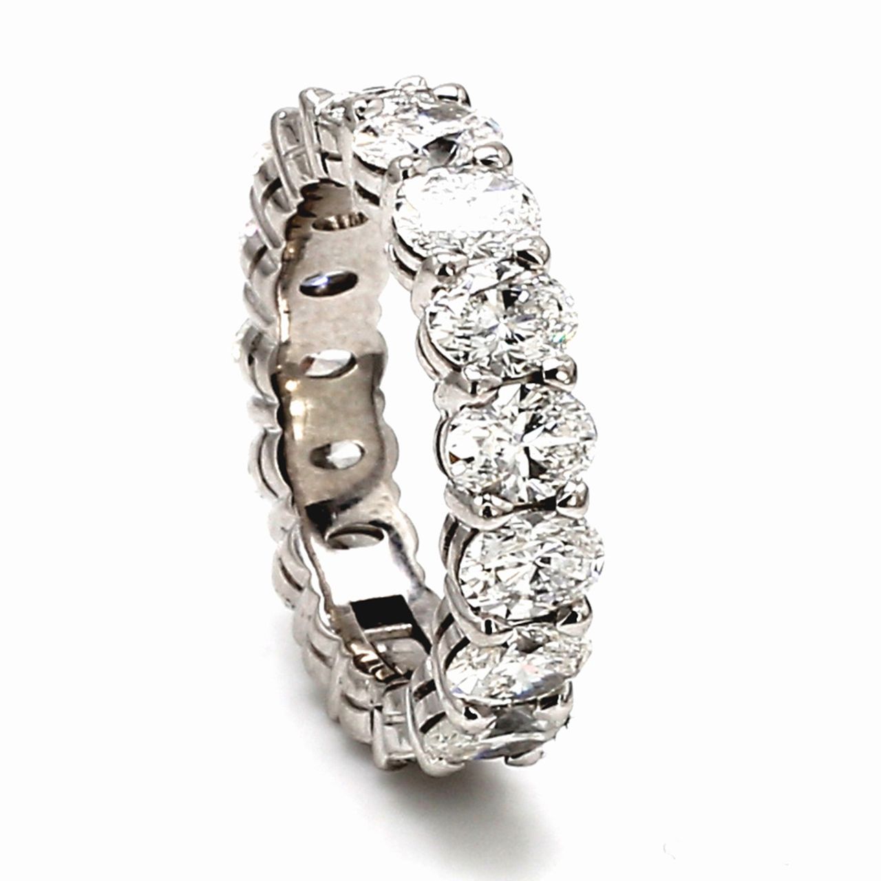 Eternity band in platinum w/ shared prong set oval diamonds & hinge and latch for easy opening.  D3.90ct.t.w.