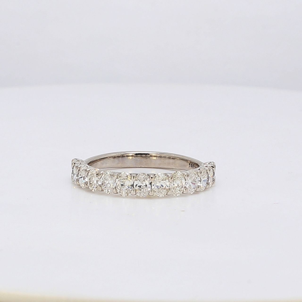 Band in white gold with half-way U-prong set oval diamonds.  D1.71ct.t.w.  Size 8.75