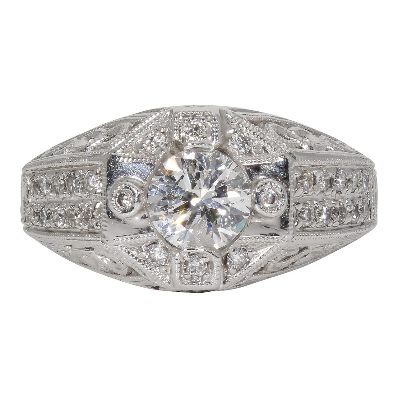 Art deco style ring in 18K WG with engravings and milligrains on the shank, pave set rounds, and prong set round center stone.  D1.31ct.t.w.  (Center 1.01ct.)