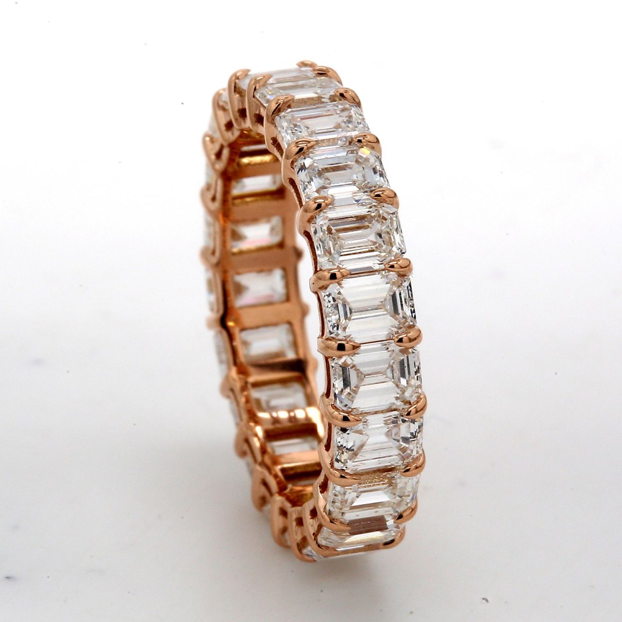 Eternity band in 18K RG with basket prong set (21) emerald cut diamonds.  D4.62ct.t.w.  Size 5.5