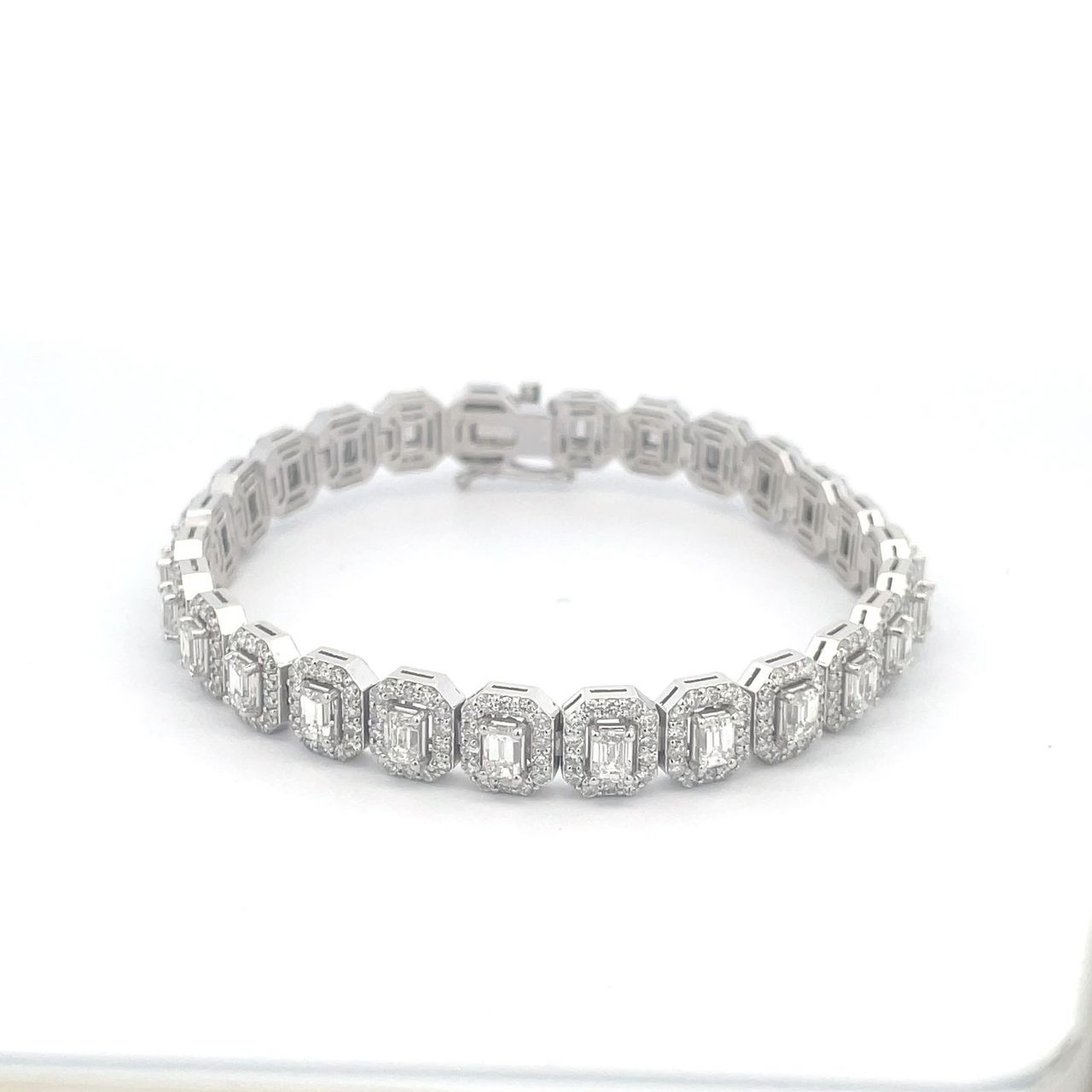 7' Halo tennis bracelet with rounds around (26) emerald cut diamond centerstones.  D8.42ct.t.w.