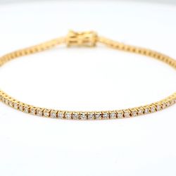 7' Tennis bracelet in yellow gold with basket prong set (92) round diamonds.  D1.41ct.t.w.