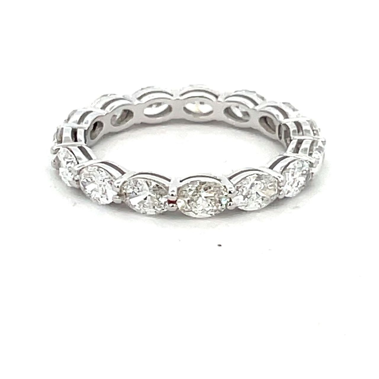 Eternity band east west style in 18K WG open basket prong set (15) oval diamonds.  D2.09ct.t.w.  Size 5.75