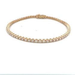 7' Tennis bracelet in yellow gold with illusion set (64) round diamonds.  D1.67ct.t.w.