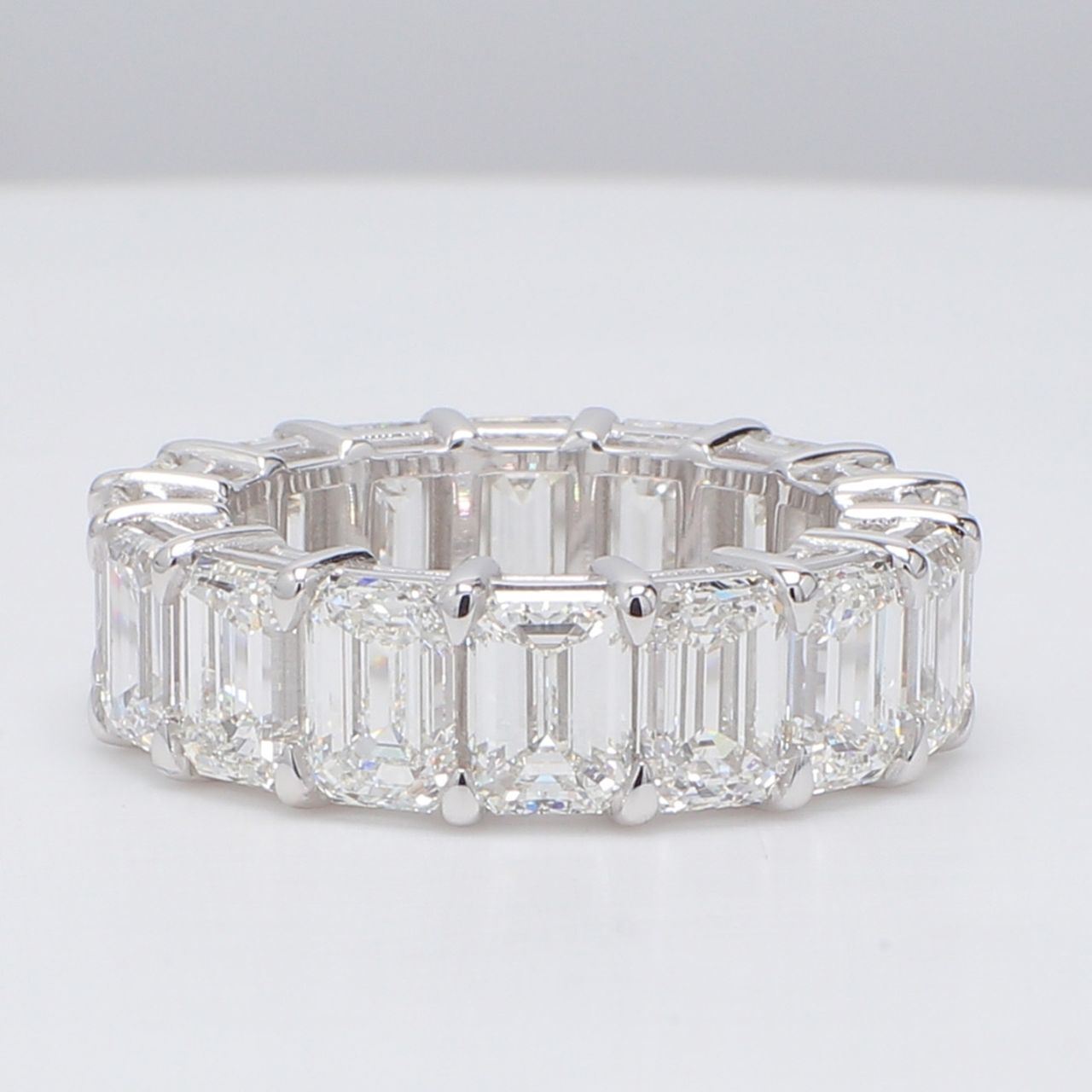 Eternity band in platinum with basket prong set D-F/VVS (16) emerald cut diamonds.  D11.78ct.t.w.  Size 6