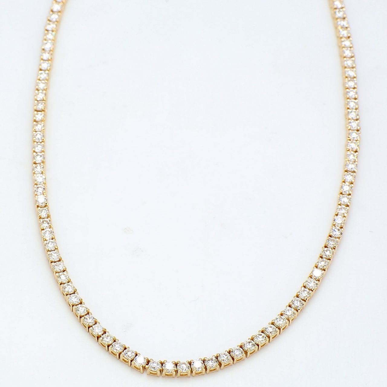 18' Tennis necklace in yellow gold with 4-prong set round diamonds.  D7.16ct.t.w.