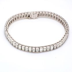 7' Tennis bracelet in platinum with half bezel set (55) emerald cut diamonds.  D13.45ct.t.w.