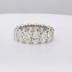 Eternity band in platinum with U-prong set G/SI (15) oval diamonds.  D7.56ct.t.w.  Size 6