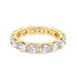 Eternity band east west style in 18K YG with prong set (14) oval diamonds.  D3.33ct.tw.  Size 6.5