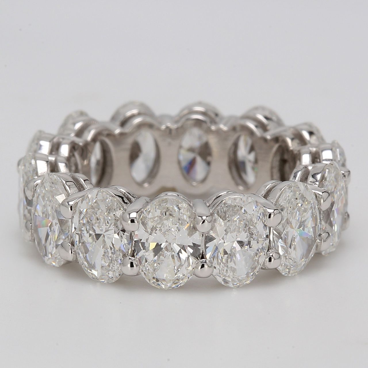 Eternity band in platinum with shared prong basket set GIA certified D-F/SI1 (14) oval diamonds.  D7.04ct.t.w.  Size 5
