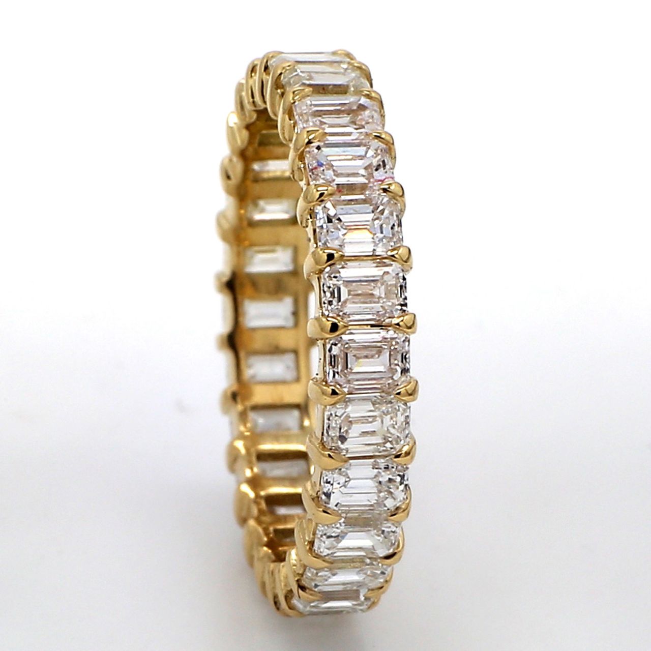 Eternity band in 18K YG with basket prong set (26) emerald cut diamonds.  D3.60ct.t.w.  Size 7