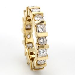 Eternity band in 14K YG with alternating channel set round & princess cut diamonds.  D2.60ct.t.w.  Size 5.75