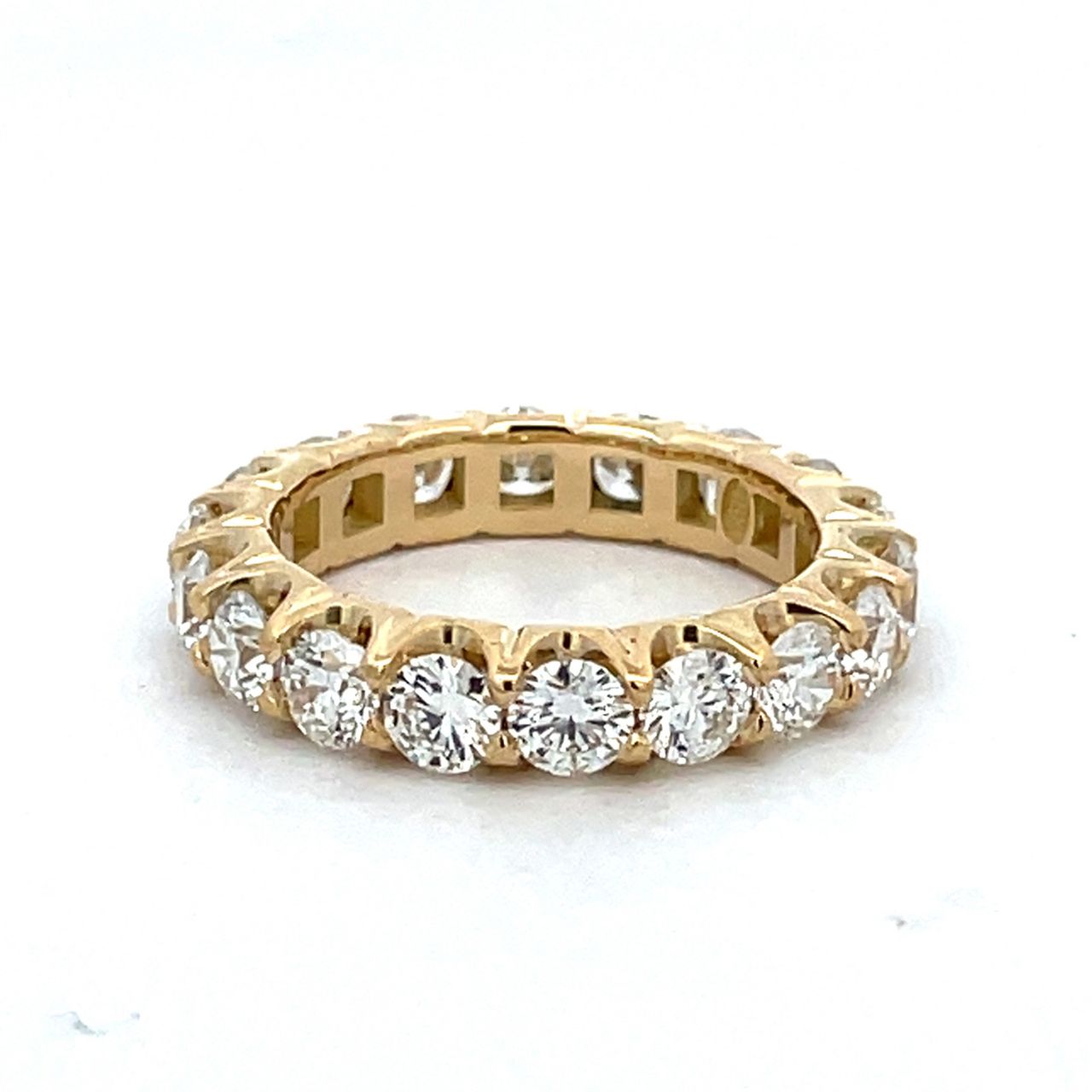 Eternity band in 18K YG with prong set (18) round diamonds.  D3.56ct.t.w.  Size 6.5
