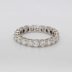 Eternity band with shared basket prong set round diamonds.  D2.07ct.t.w.  Size 4.5