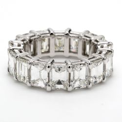 Eternity band in platinum with shared prong set emerald cut diamonds.  D9.05ct.t.w.