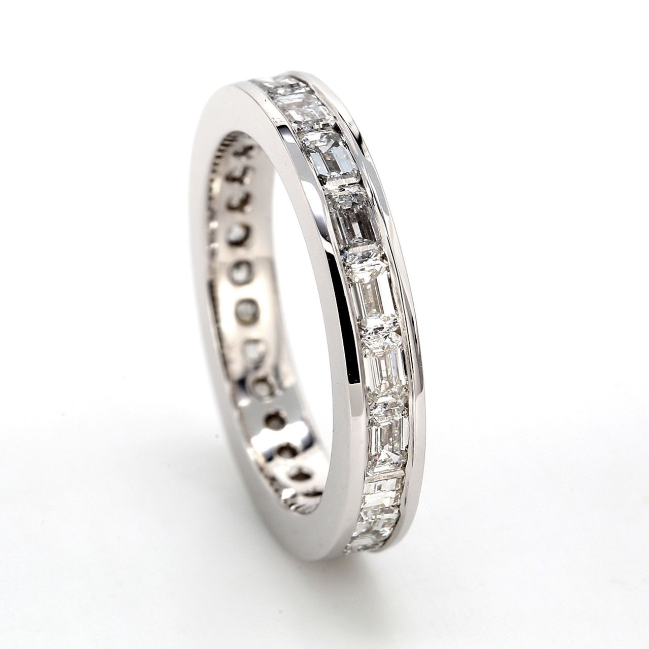East to west style eternity band with channel set (20) emerald cut diamonds.  D2.32ct.t.w.  Size 6.25