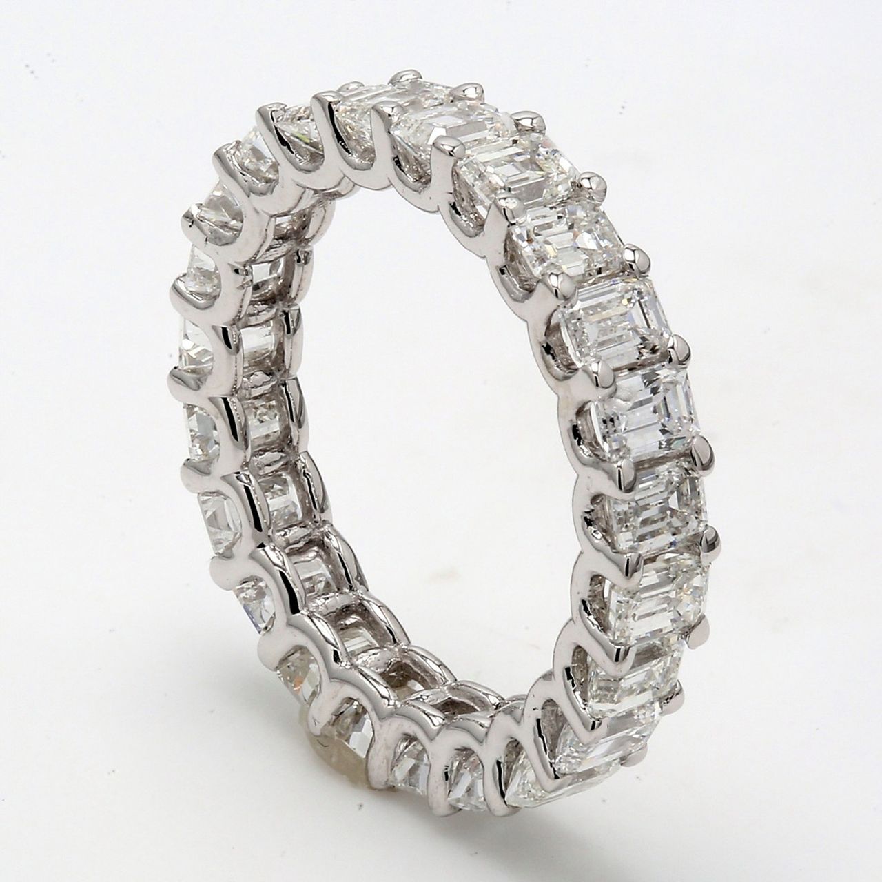 Eternity band with shared U-prong set emerald cut diamonds.  D6.91ct.t.w.