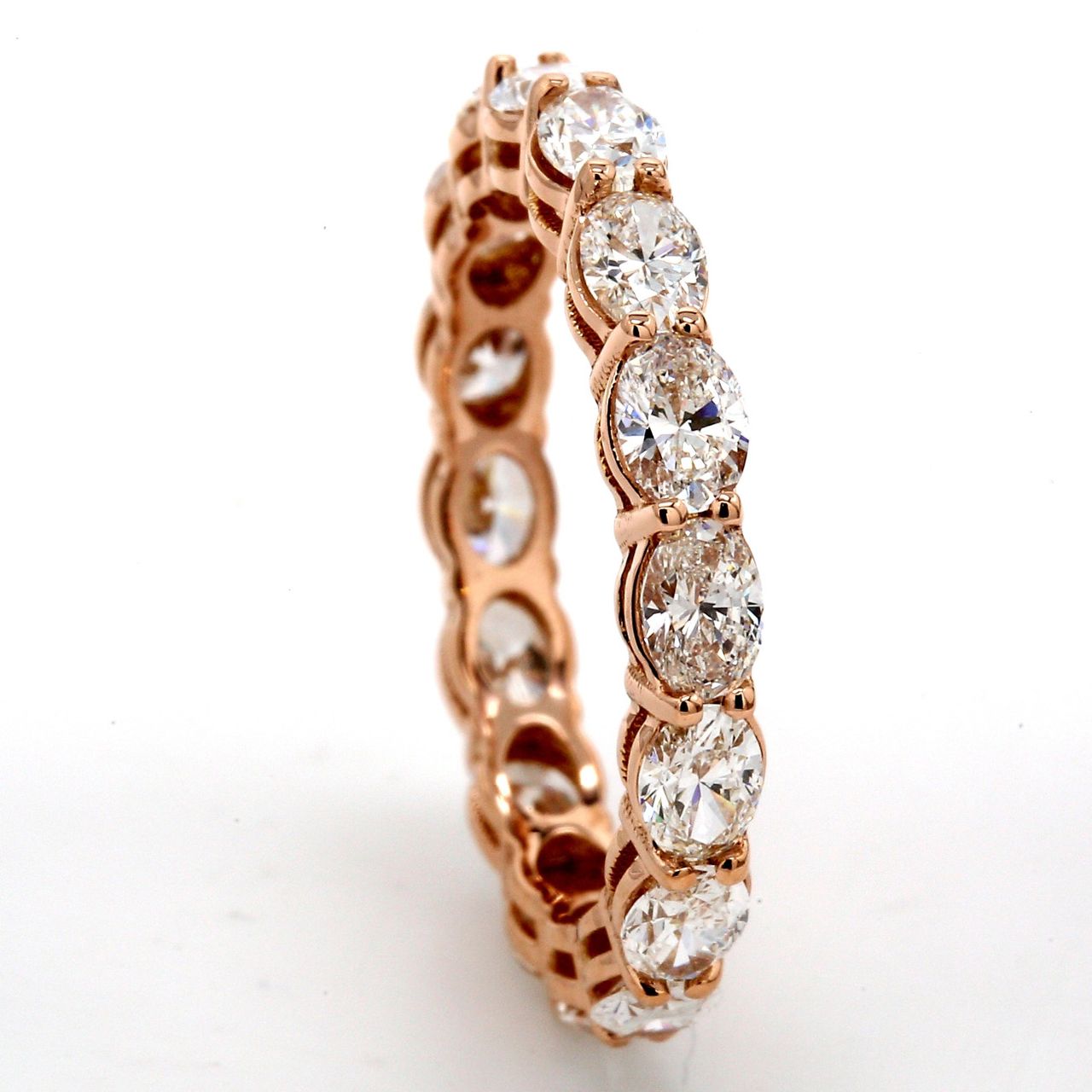 Eternity band east to west style in 18K RG with basket prong set (16) oval cut diamonds.  D2.18ct.t.w.  Size 6