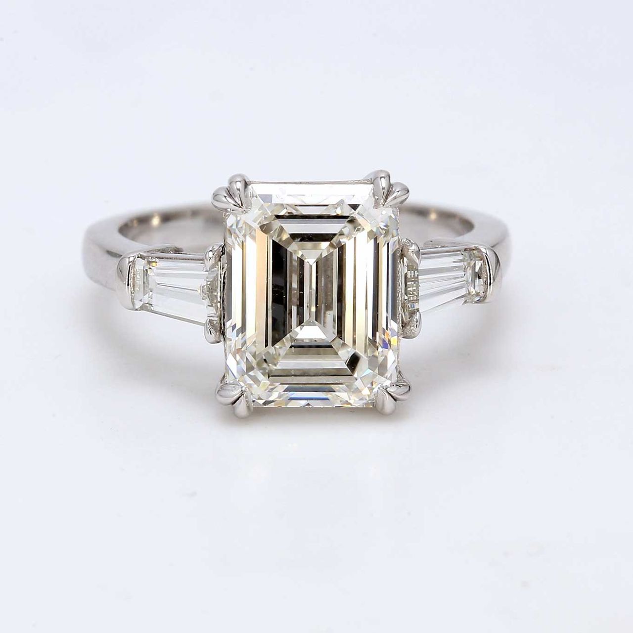 3-stone semi-mount in platinum with prong set tapered baguette diamond sides.  D0.63ct.t.w.