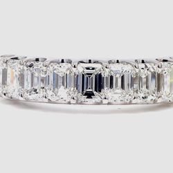 9-stone band in platinum with U-prong set emerald cut diamonds.  D2.75ct.t.w.  Size 7.5