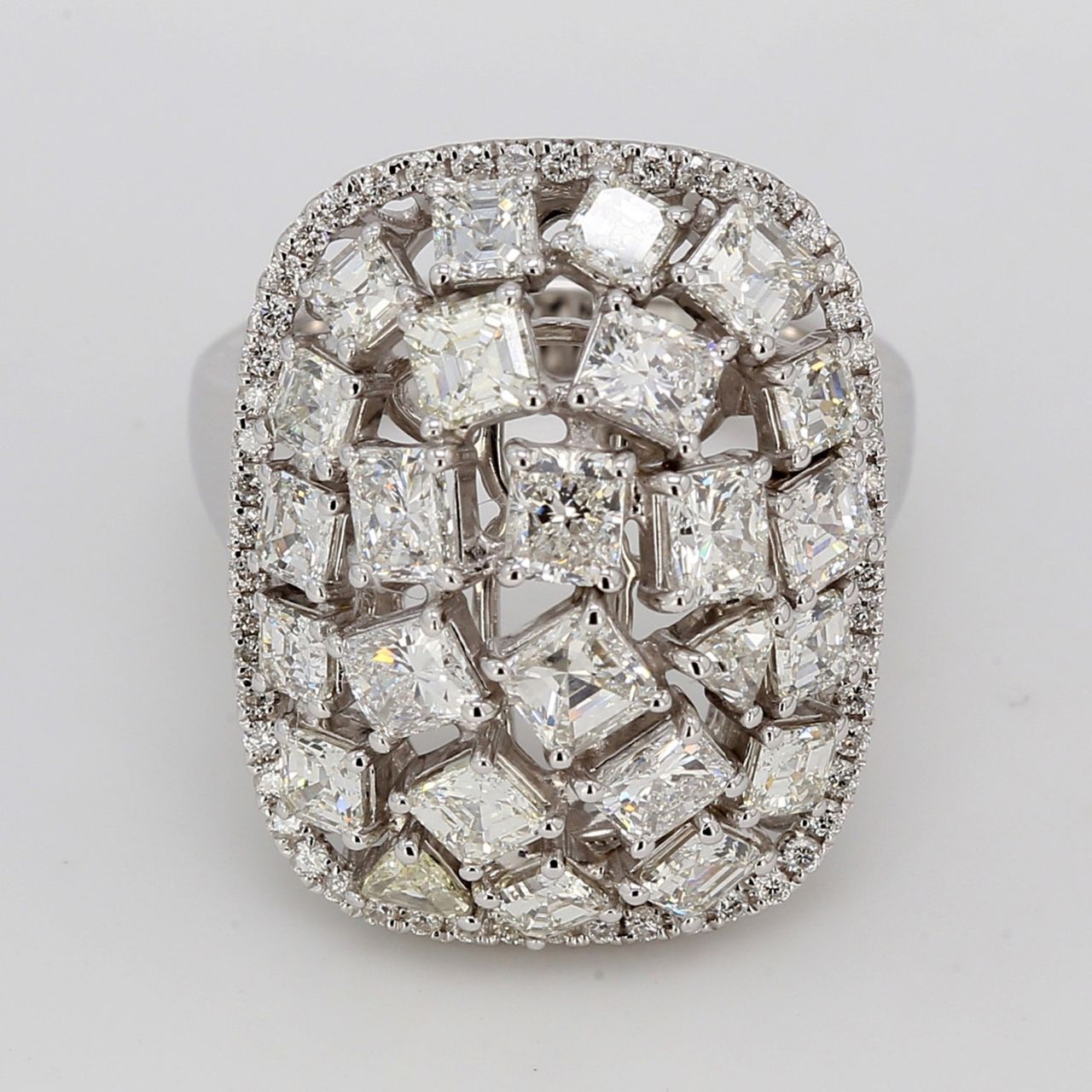 Halo fashion ring in 18K WG with french pave set rounds around prong set asscher, princess, radiant, & trilliant cut diamonds in the middle.  D3.95ct.t.w.
