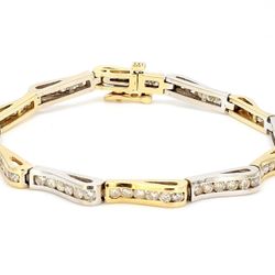 Wave design bracelet in two-tone with channel set round diamonds.  D2.50ct.t.w.