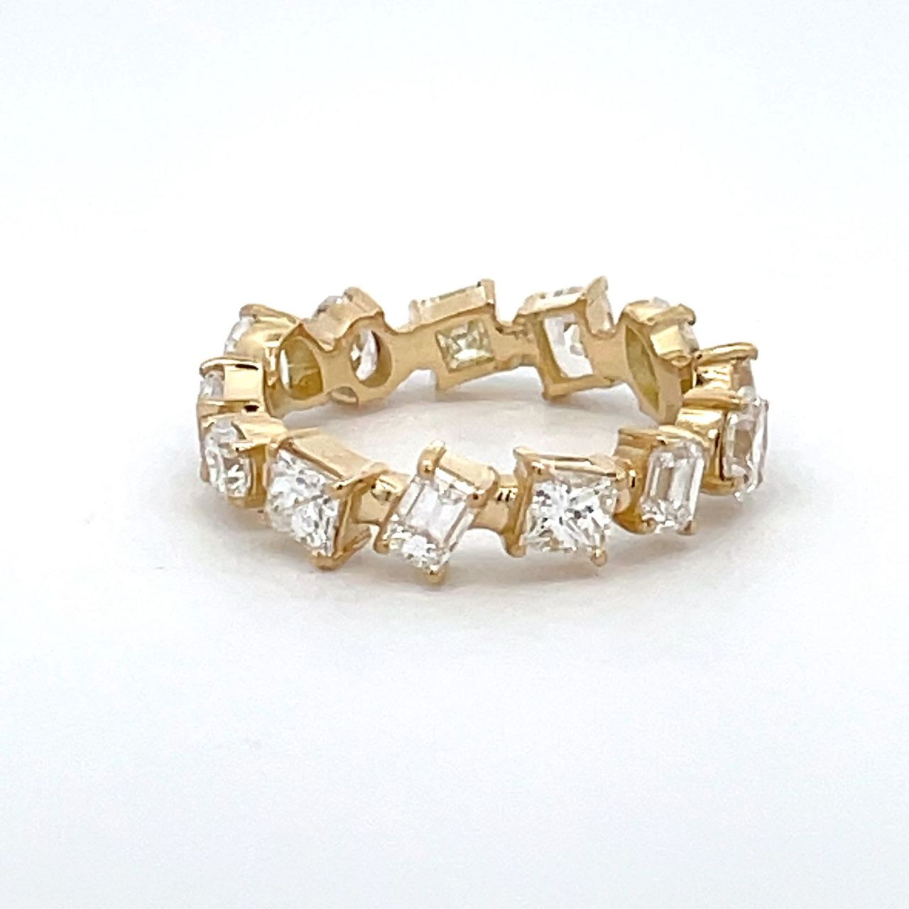 Eternity band in 18K YG with 4-prong set multi shape diamonds.  D2.48ct.t.w.  Size 5.75