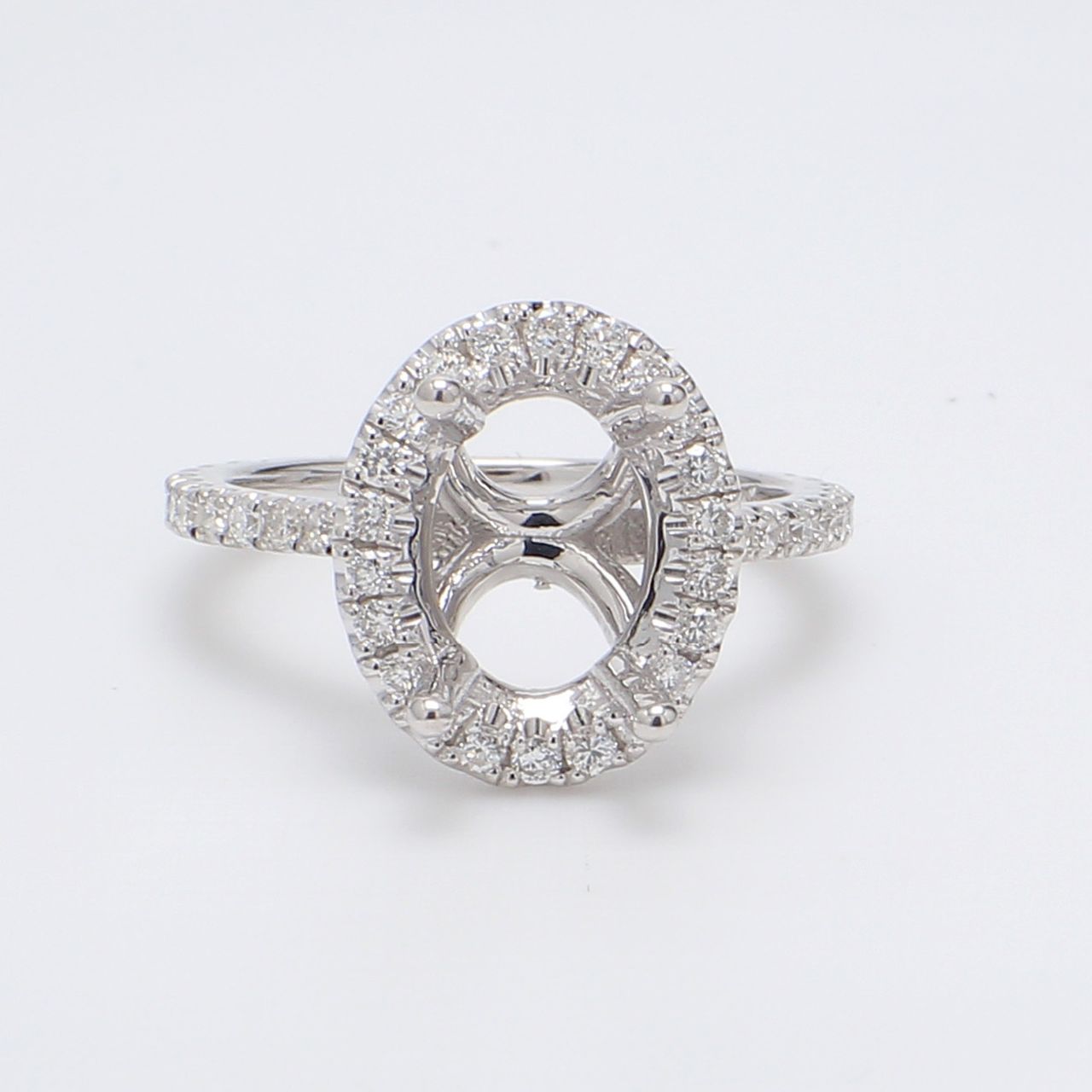 Halo semi-mount with shared prong set round diamonds.  D0.52ct.t.w.  Size 4.75