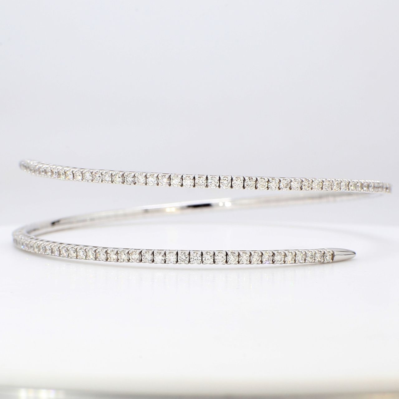 Flexible bangle in 18K WG with 4-prong set round diamonds.  D2.28ct.t.w.