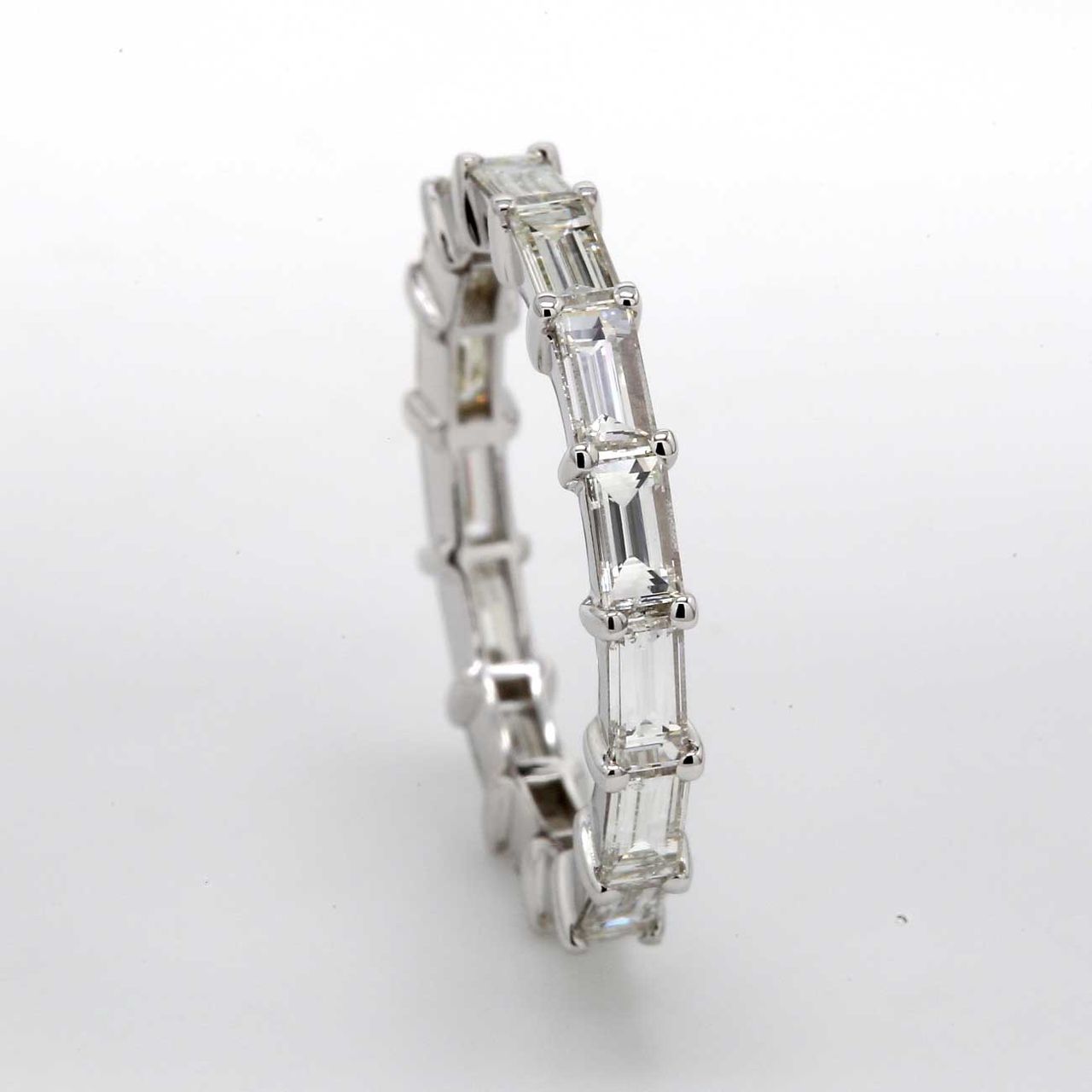 East to west style eternity band in 18K WG with shared prong set (15) baguette diamonds.  D1.75ct.t.w.  Size 4.75