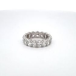 Eternity band in platinum with basket claw prong set GIA certified D-F/VS2-SI2 (17) oval cut diamonds.  D5.26ct.t.w.  Size 6