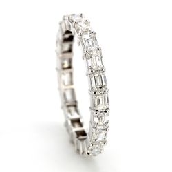 East to west style eternity band with shared prong basket set emerald cut diamonds.  D2.88ct.t.w.  Size 6.75