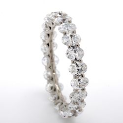 Eternity band in platinum with shared U-prong set (22) oval cut diamonds.  D3.12ct.t.w.  Size 6.25