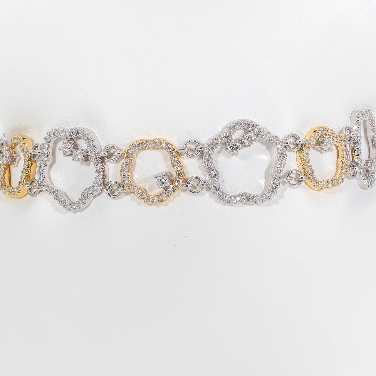 Star shaped link bracelet in 18K two-tone with prong set round diamonds.  D2.77ct.t.w.