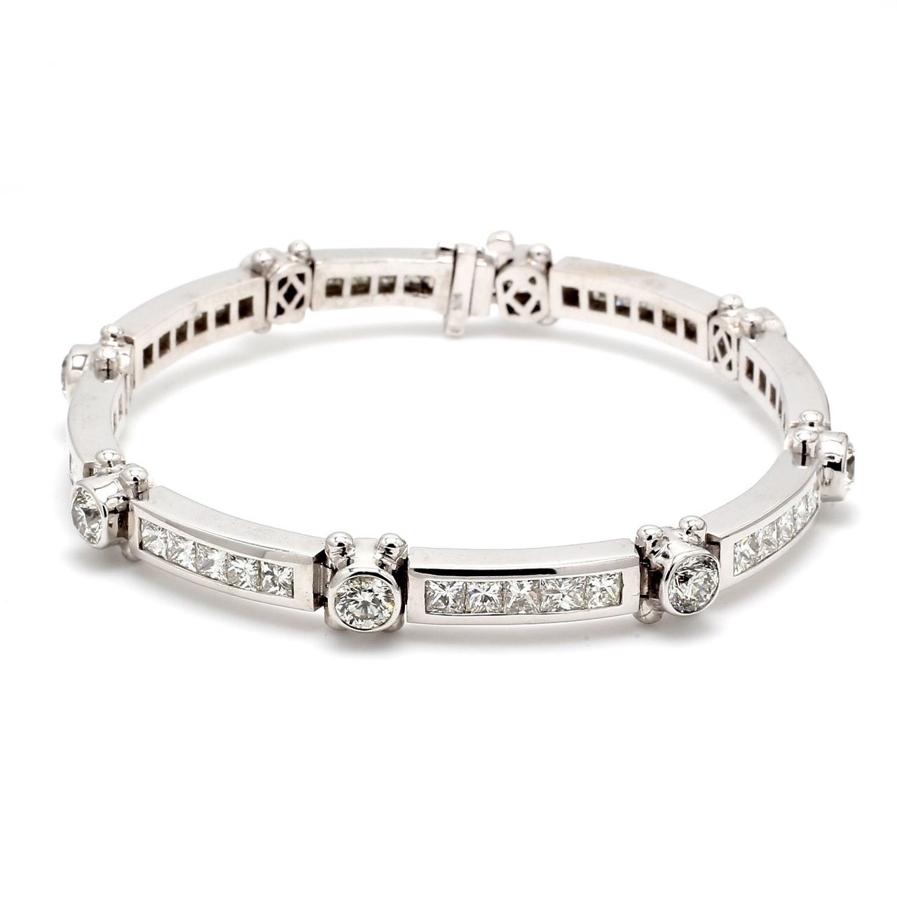 8' Link bracelet with alternating bezel set rounds & channel set princess cut diamonds.  D12.11ct.t.w.