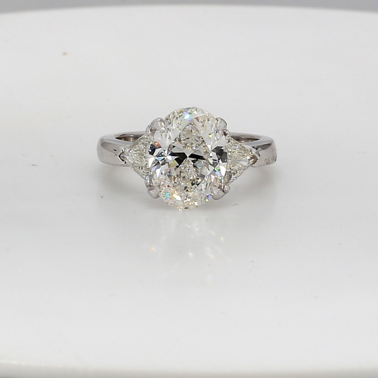 3-stone semi-mount in platinum with claw prong set trilliant cut diamond sides.  D0.69ct.t.w.