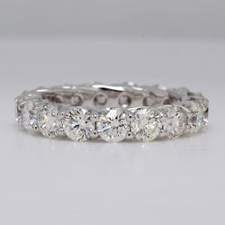 Eternity band in 18K WG with lucida style shared prong set round diamonds.  D3.92ct.t.w.  Size 6.25